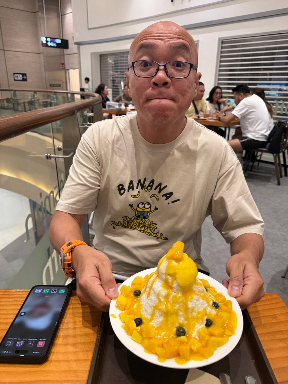 Man holding a mango shaved ice dessert